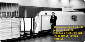 Founds Rick Koetter and Tom Koetter standing in front of the first model KDK-001 dry kiln, circa 1987